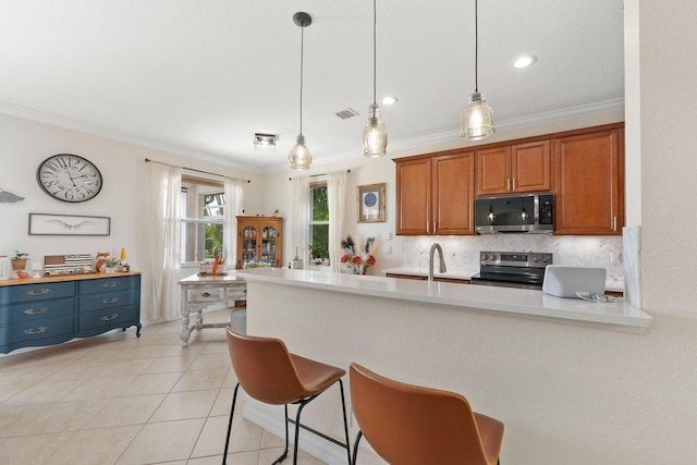 kitchen featuring ornamental molding, appliances with stainless steel finishes, and tasteful backsplash