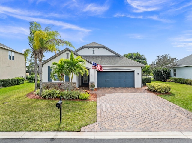 view of front of home featuring an attached garage, a front lawn, decorative driveway, and stucco siding