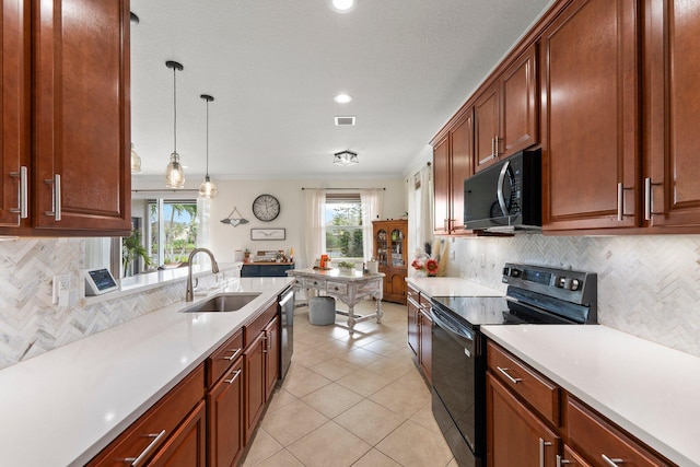 kitchen with light countertops, a sink, visible vents, and black appliances