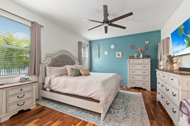 bedroom featuring a ceiling fan and dark wood-style flooring