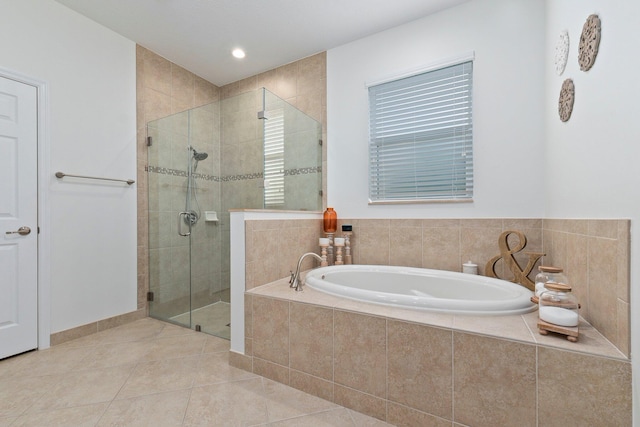 bathroom with a stall shower, tile patterned flooring, and a garden tub