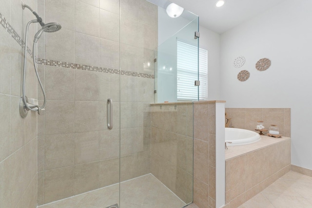 full bath featuring a stall shower, tile patterned flooring, and a garden tub