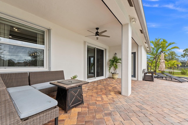 view of patio with ceiling fan and fence