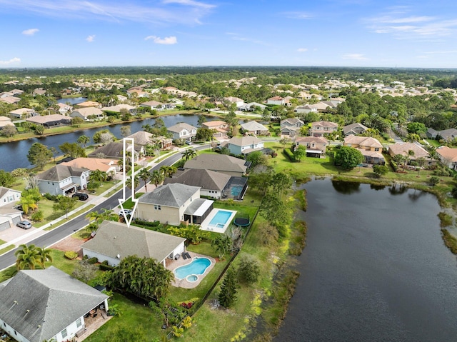 drone / aerial view featuring a residential view and a water view