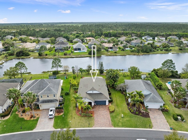 drone / aerial view featuring a water view and a residential view