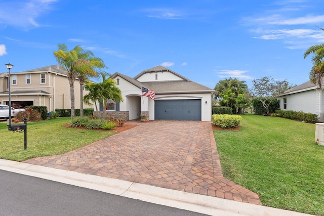 view of front facade featuring a garage, a front lawn, decorative driveway, and stucco siding