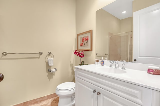 full bathroom featuring vanity, baseboards, a stall shower, tile patterned floors, and toilet
