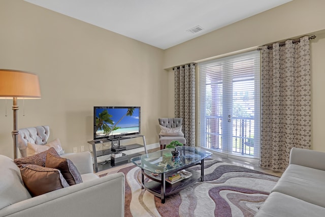 living area featuring baseboards and visible vents