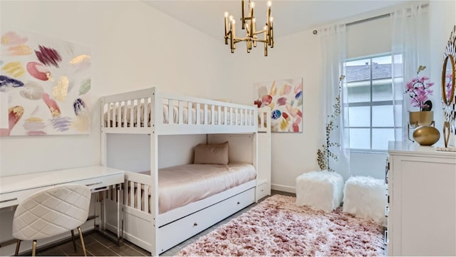 bedroom featuring baseboards and a notable chandelier