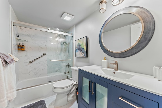 full bathroom featuring enclosed tub / shower combo, vanity, and toilet