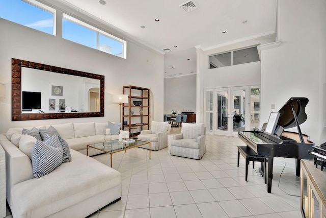 living area with visible vents, ornamental molding, french doors, a high ceiling, and light tile patterned floors