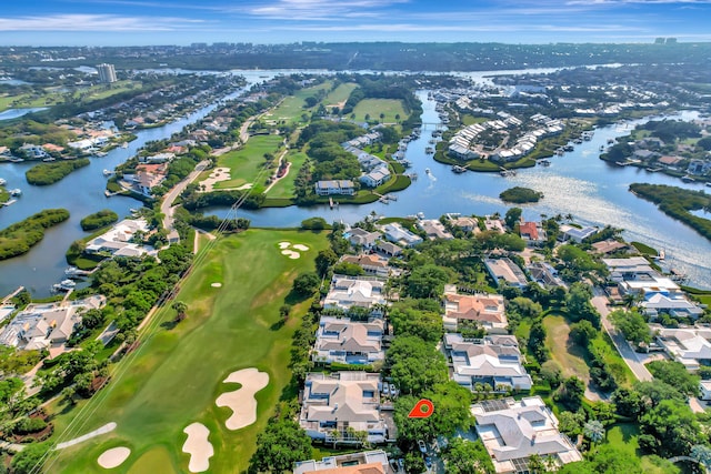 aerial view with a residential view, view of golf course, and a water view