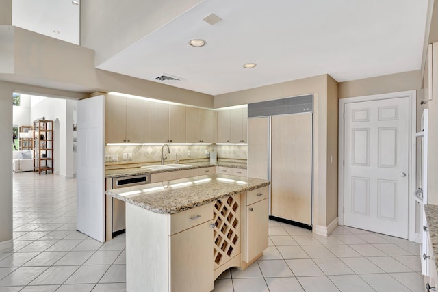 kitchen featuring paneled fridge, visible vents, a sink, stainless steel dishwasher, and backsplash