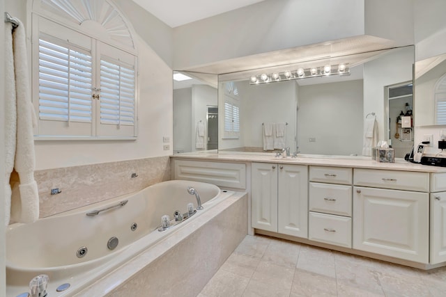 bathroom with vanity, tile patterned floors, and a whirlpool tub