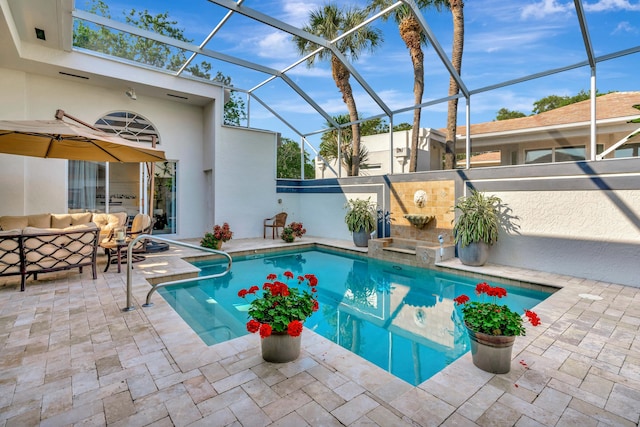 view of swimming pool featuring a patio area, a fenced in pool, an outdoor hangout area, and glass enclosure