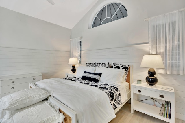 bedroom featuring lofted ceiling and light wood-style floors