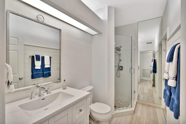 full bathroom with visible vents, a shower stall, toilet, and vanity