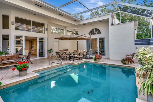 back of property featuring glass enclosure, a patio, outdoor dining area, an outdoor pool, and stucco siding