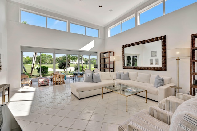 tiled living area with a towering ceiling