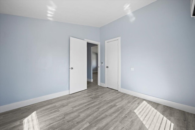 empty room featuring baseboards and wood finished floors