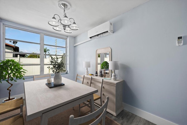 dining room with baseboards, an AC wall unit, dark wood-type flooring, and a notable chandelier