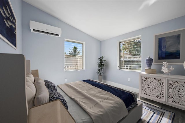 bedroom featuring vaulted ceiling and a wall mounted AC