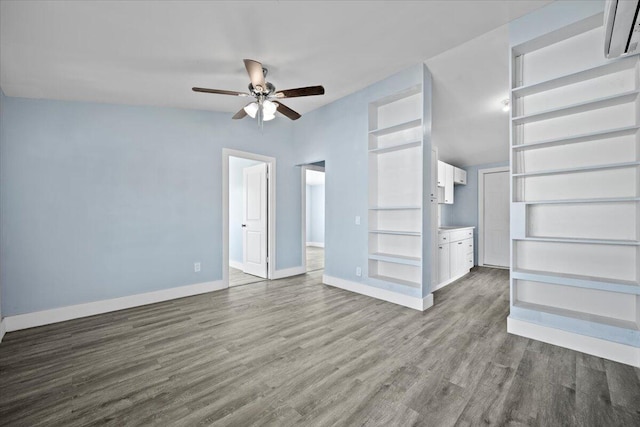 unfurnished living room with dark wood-style floors, ceiling fan, and baseboards