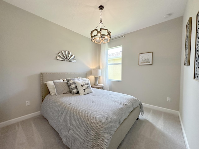 bedroom with carpet, a notable chandelier, and baseboards