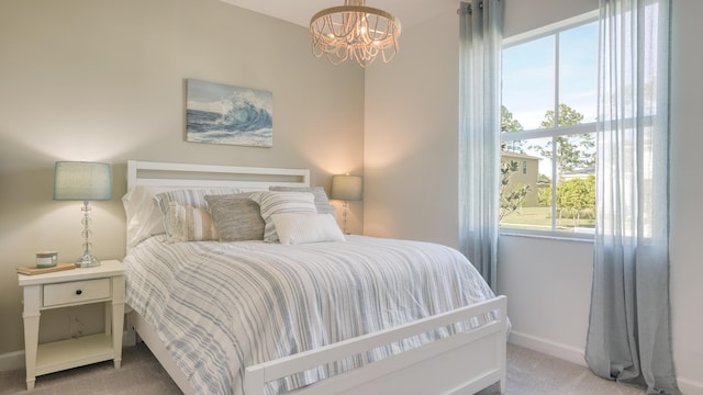 bedroom featuring carpet, a notable chandelier, and baseboards