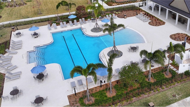 community pool featuring a patio area and fence