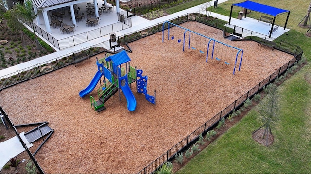 community jungle gym with a patio and fence