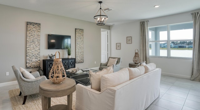 living room with light tile patterned floors, baseboards, visible vents, and a notable chandelier