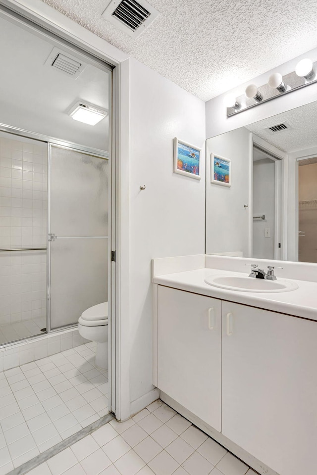 full bath with a textured ceiling, toilet, a shower stall, and visible vents