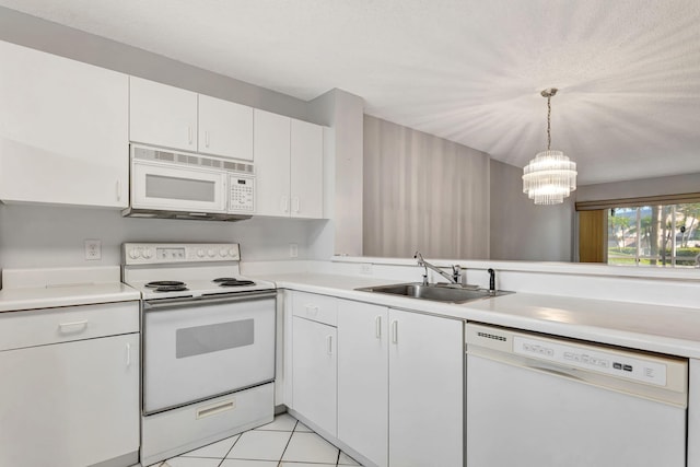 kitchen featuring white appliances, light countertops, a sink, and light tile patterned floors