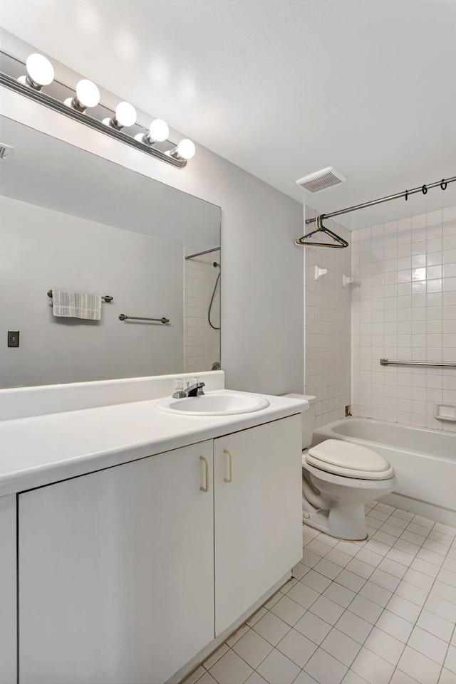 bathroom featuring toilet, visible vents, bathing tub / shower combination, vanity, and tile patterned floors