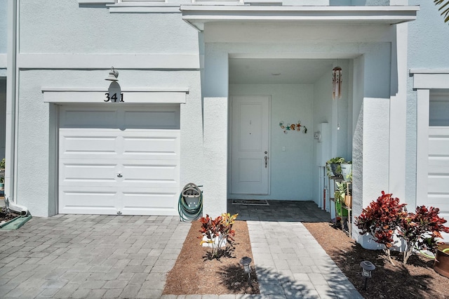 entrance to property with stucco siding