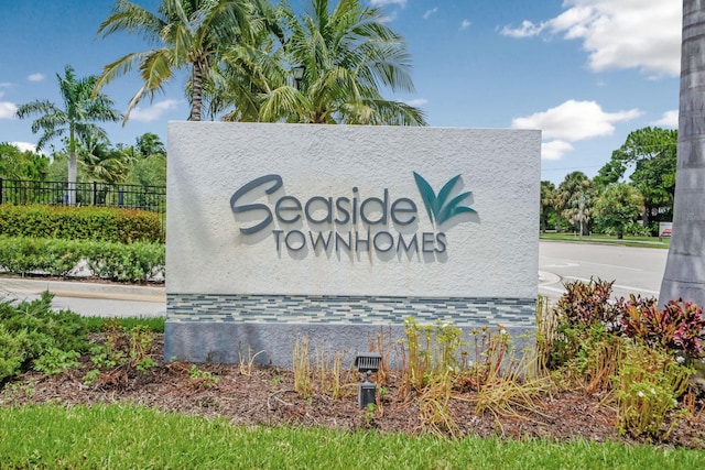 community / neighborhood sign featuring fence