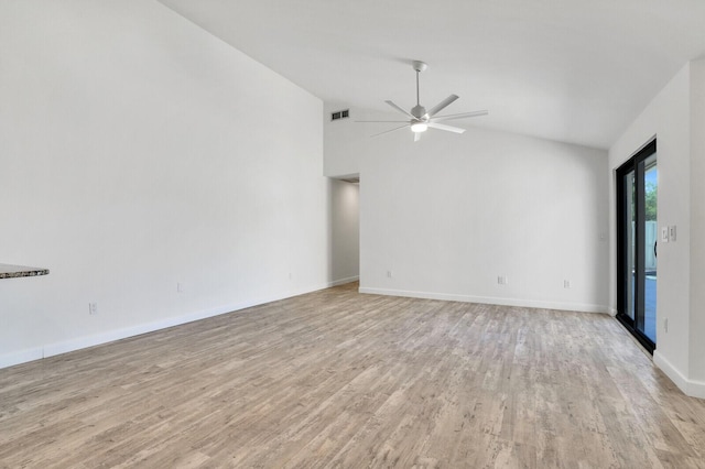 spare room featuring a ceiling fan, visible vents, baseboards, vaulted ceiling, and light wood-style floors