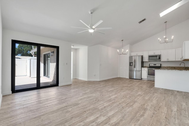 unfurnished living room with visible vents, ceiling fan with notable chandelier, light wood-style floors, high vaulted ceiling, and a sink