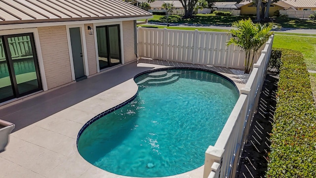 view of swimming pool with a patio area, a fenced in pool, and fence