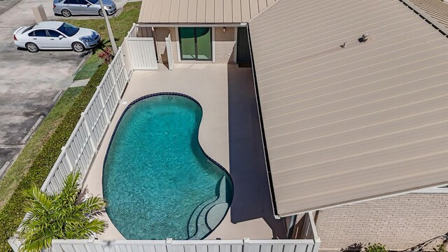 view of swimming pool featuring a fenced in pool and fence