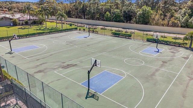 view of basketball court featuring community basketball court and fence