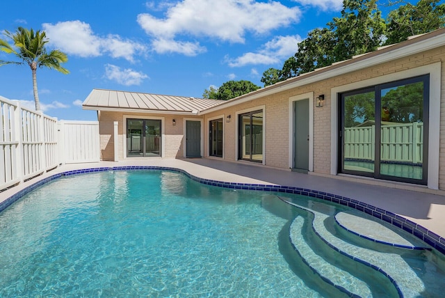 view of swimming pool featuring a patio, a fenced in pool, and fence