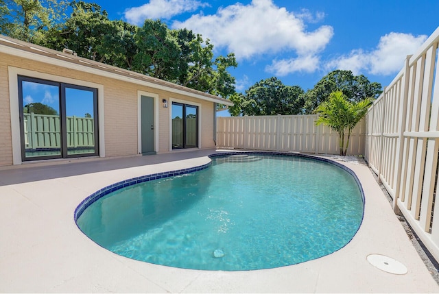 view of swimming pool with a fenced in pool, a patio, and a fenced backyard