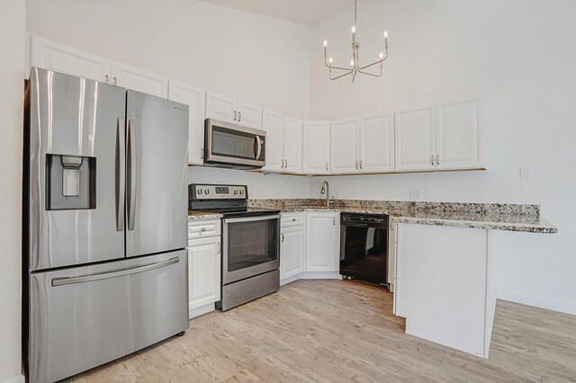 kitchen featuring white cabinetry, light stone countertops, and appliances with stainless steel finishes