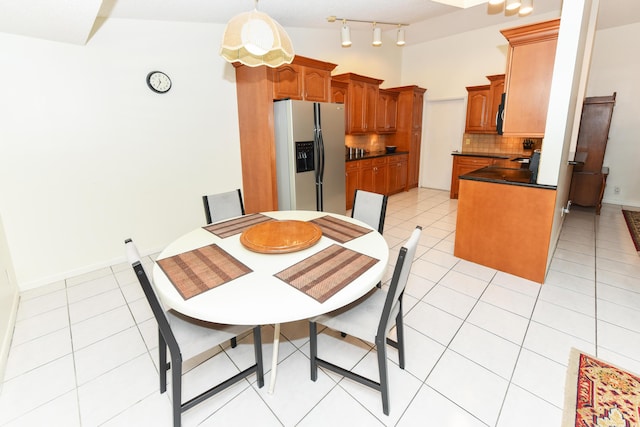 dining space with light tile patterned floors and baseboards