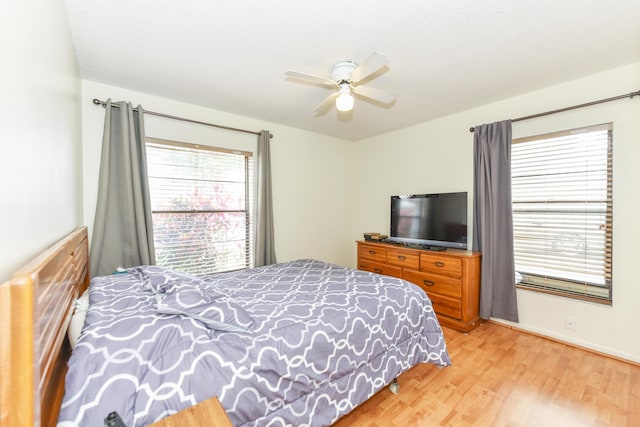 bedroom with light wood-style floors and ceiling fan