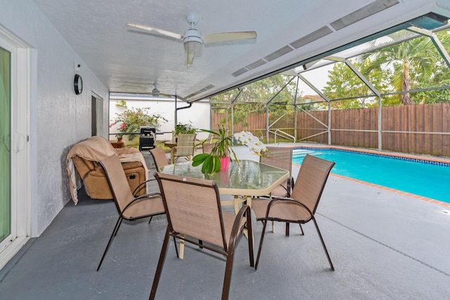 exterior space with a fenced backyard, a lanai, a ceiling fan, a fenced in pool, and a patio area