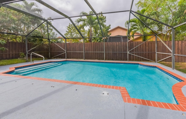 view of pool with a fenced in pool, glass enclosure, a patio area, and a fenced backyard