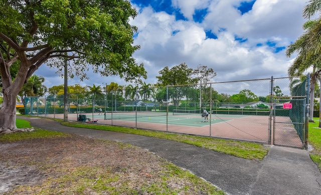 view of sport court featuring a gate and fence